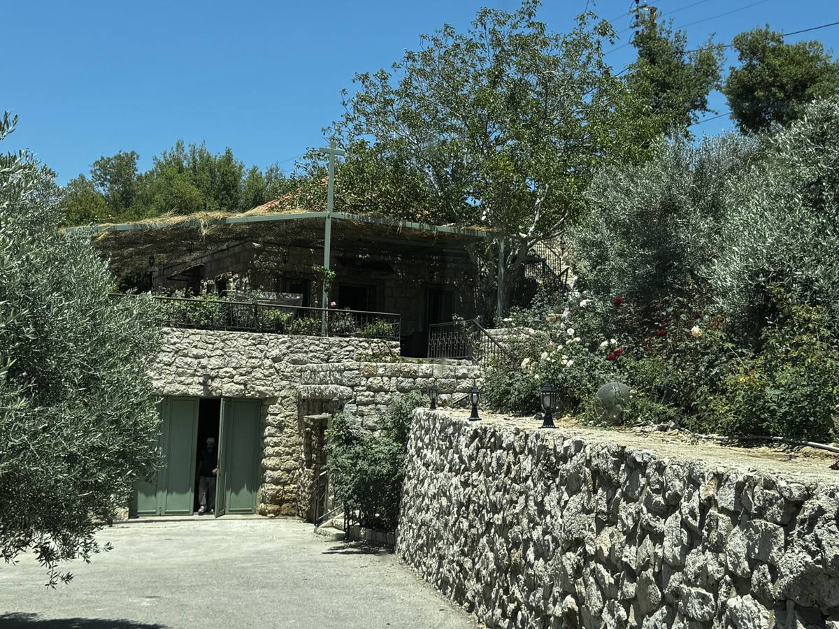 The stone house at Mechmech with its green doors and dry-stone walls