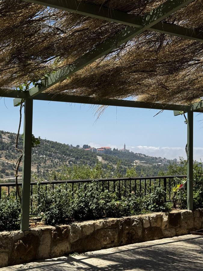 The view from under the pergola toward the monastery of Annaya and the sea